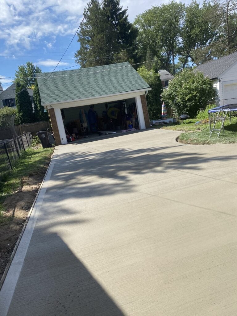 New concrete driveway leading to a detached two-car garage on Calvin Avenue in Grosse Pointe Farms, MI