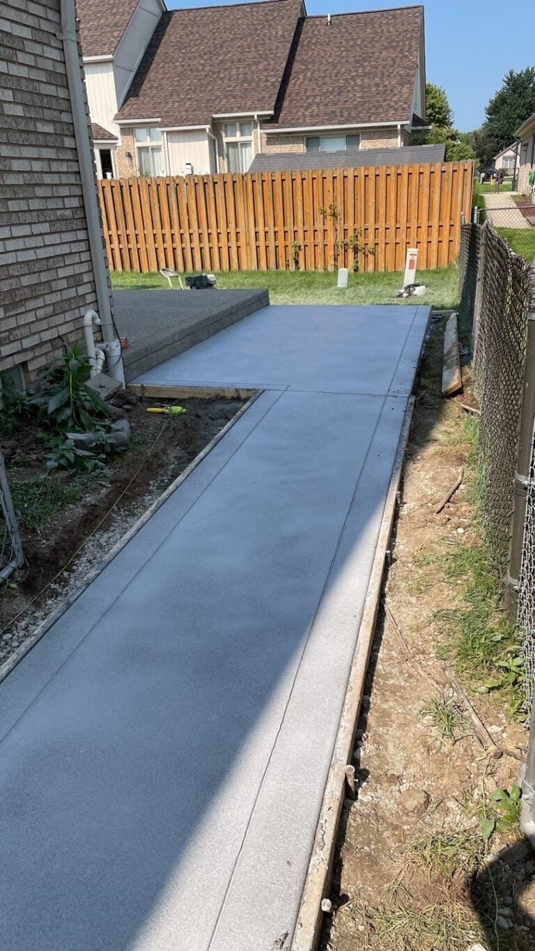 Freshly poured concrete walk and patio along the side of a home on Maurice Drive in Chesterfield, MI