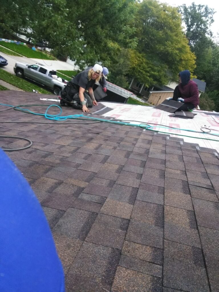 Rock Solid Exteriors crew installing new shingles over underlayment on Bristol Drive in Troy, MI