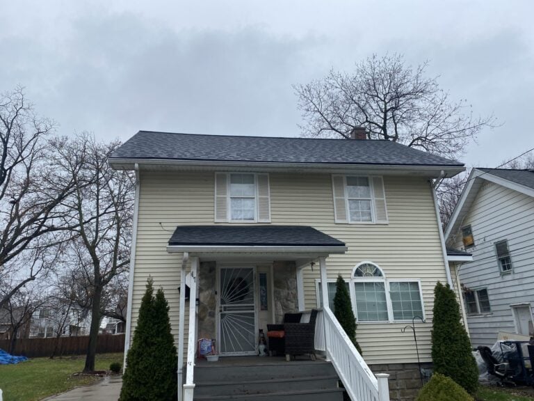 Two-story home with tan siding and a newly installed dark shingle roof on Mark Avenue in Pontiac, MI