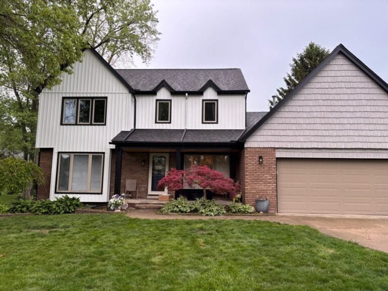 Two-story home with new white vertical siding and black-trimmed windows on Gail Street in Clinton Township, MI