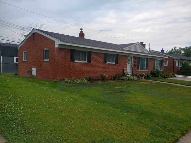Single-story red brick ranch with new siding accents on the gables on Shoreview Street in St. Clair Shores, MI